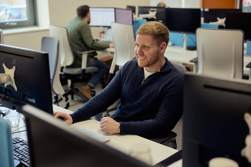 Male SmartSearch Employee at desk working