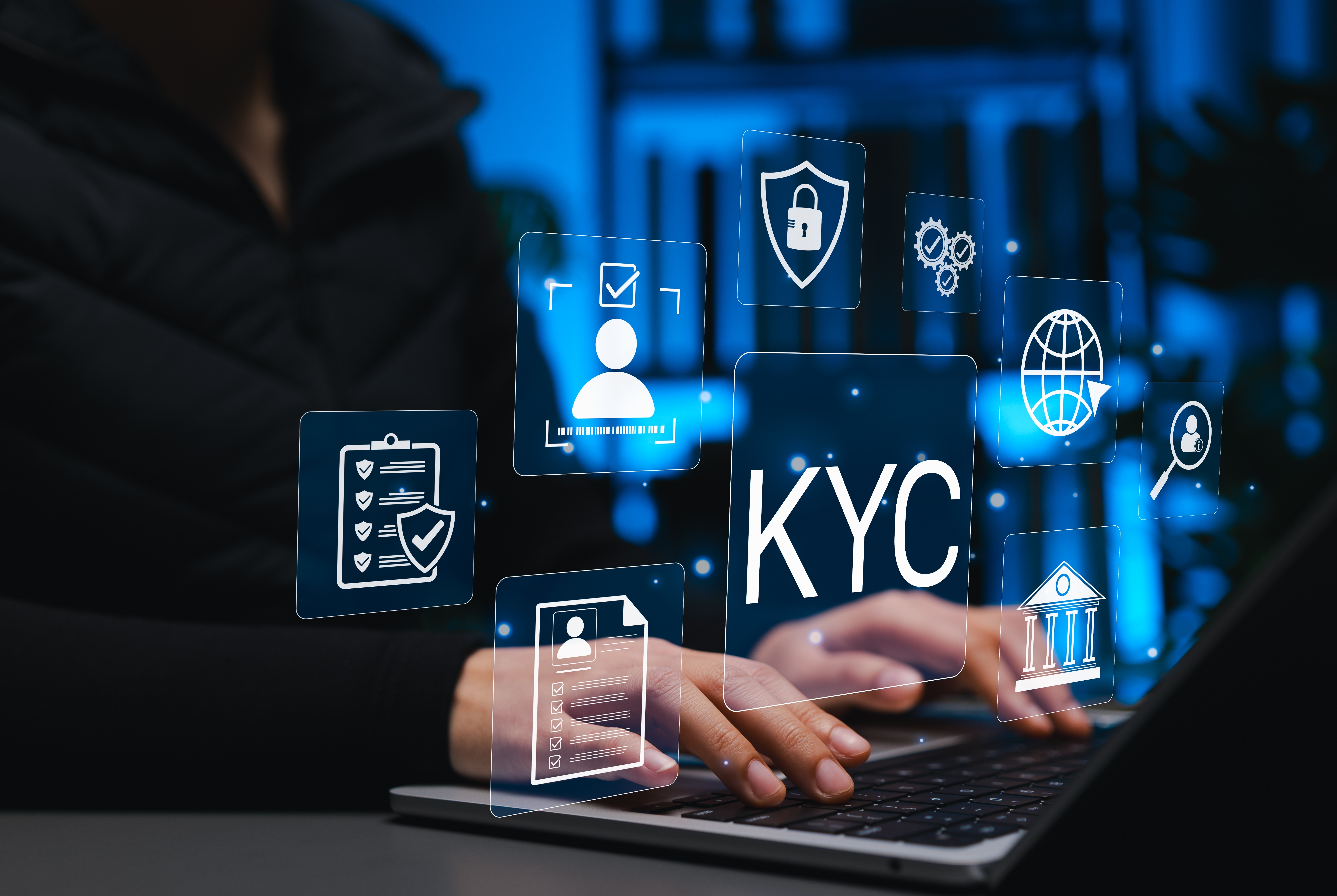 Man sat in front of a laptop with floating images highlighting that they are working on KYC for a business.