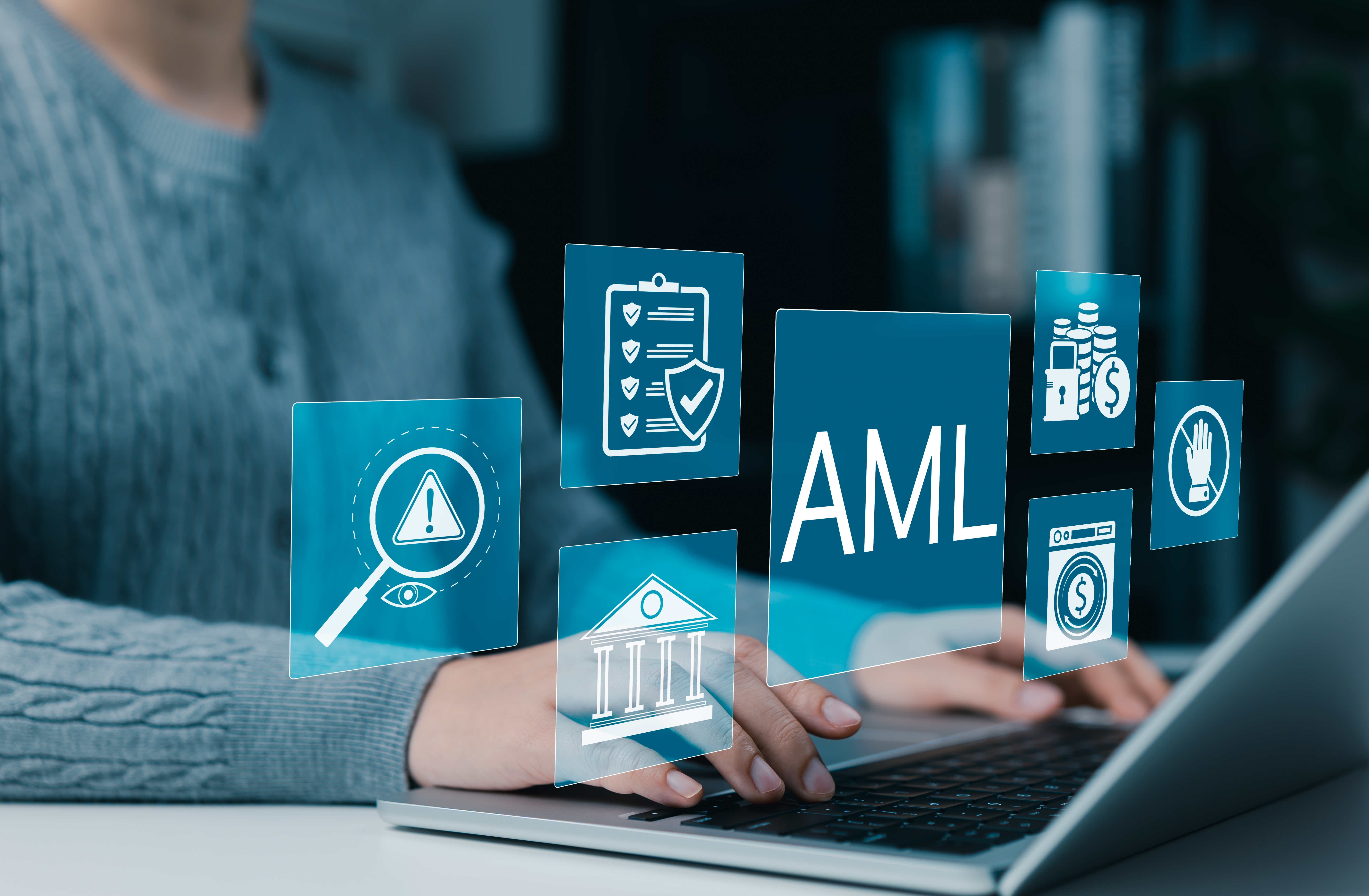 Man wearing a suit, sat in front of a laptop with floating icons displaying aspects of transaction monitoring in anti money laundering.